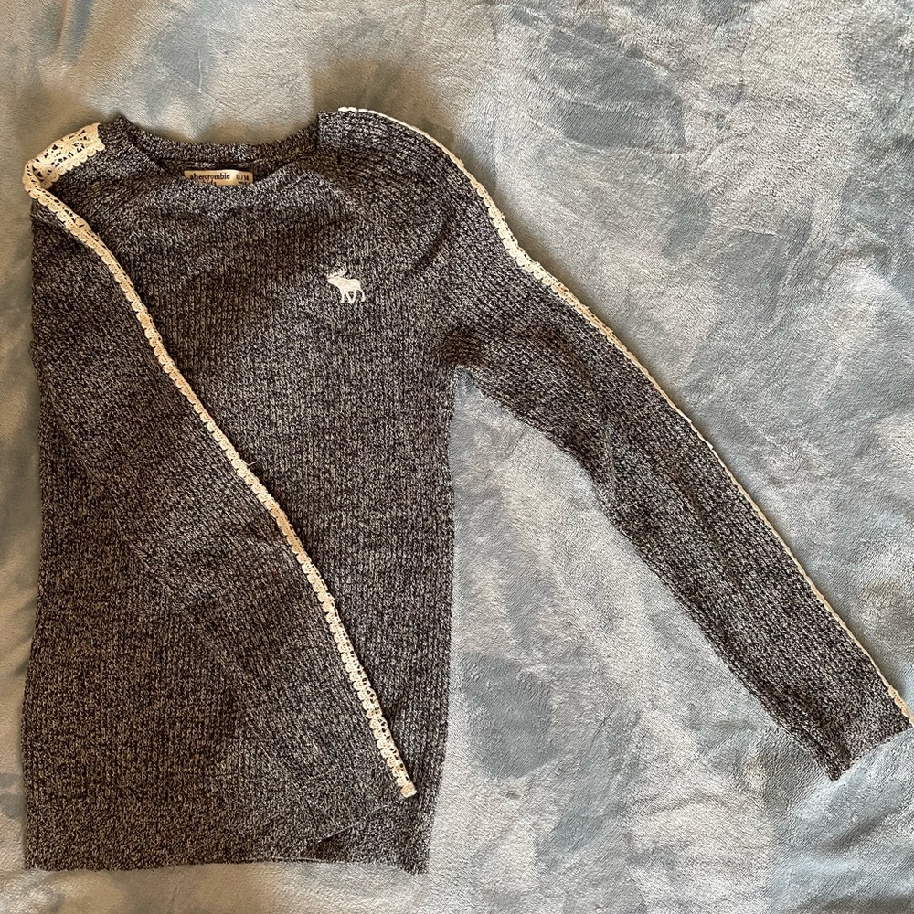 Black & white kids sweater with white detailing.